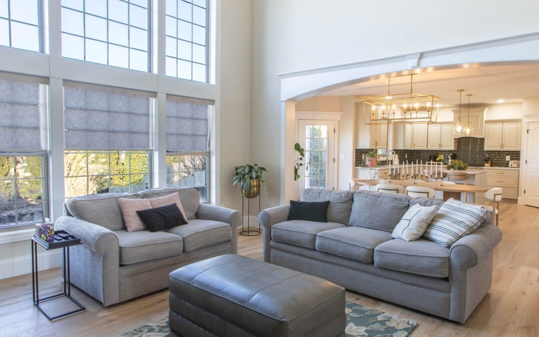 Timeless open concept living room renovation in Central Illinois with large windows, neutral tones, and comfortable seating by Shawluxe.